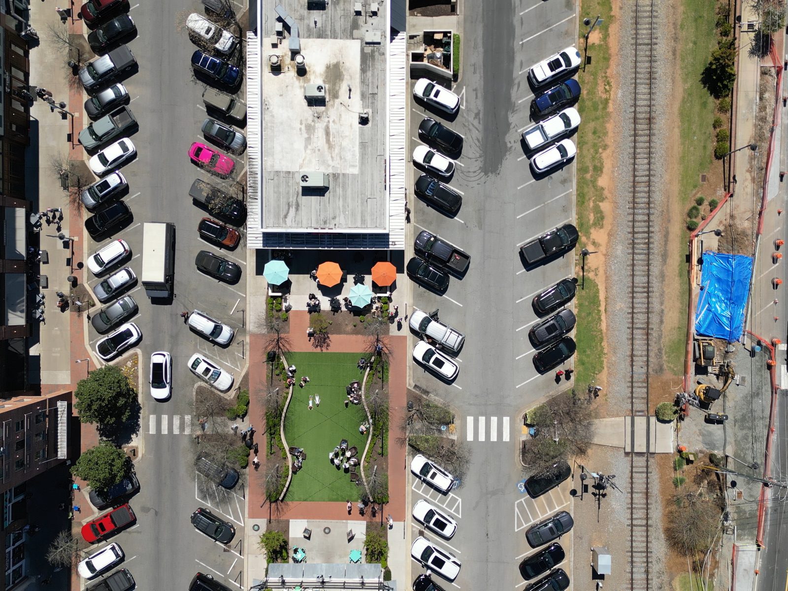 A downtown street and pocket park during an event